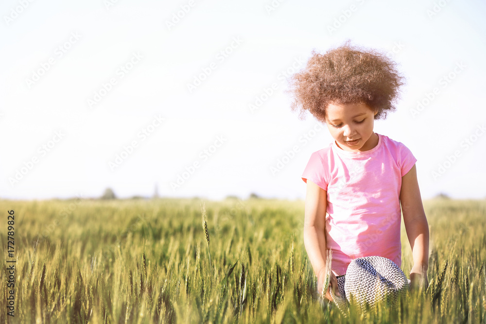 Little Afro American girl in green field Stock Photo | Adobe Stock