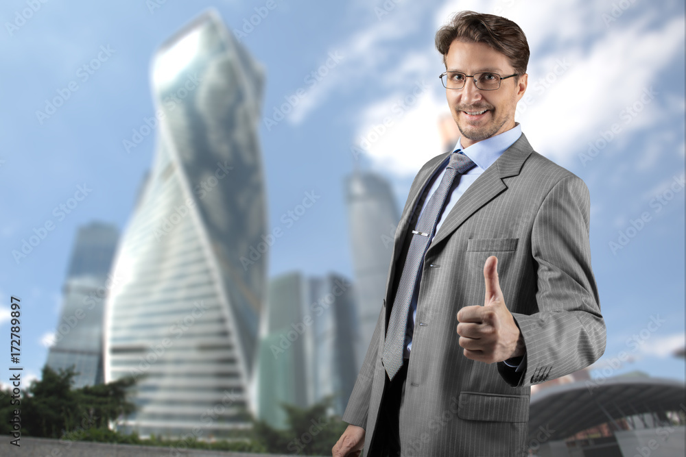Businessman in gray suit smiling and thumb up Businessman in gray suit smiling and thumb up