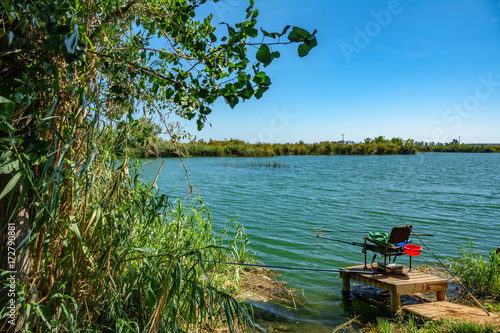 Fishing in a lake with chair and rods