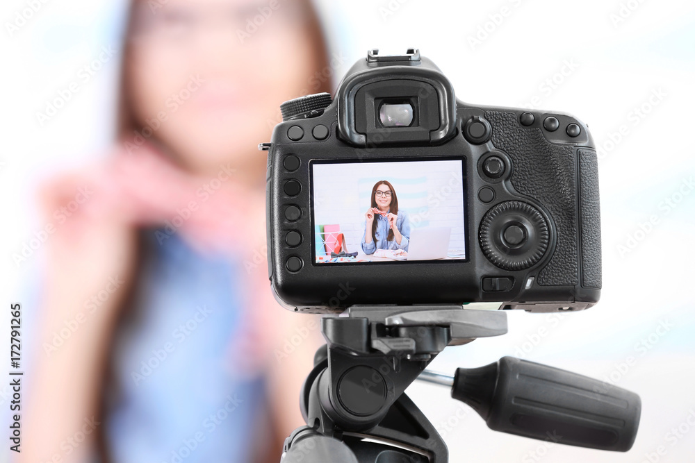 Young woman recording video at home. Beauty blog concept
