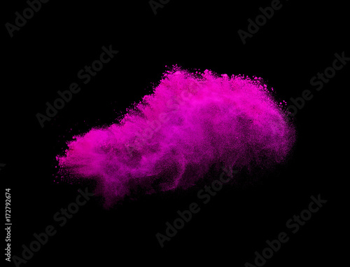 Powder explosion. Closeup of pink dust particle explosion isolated on background