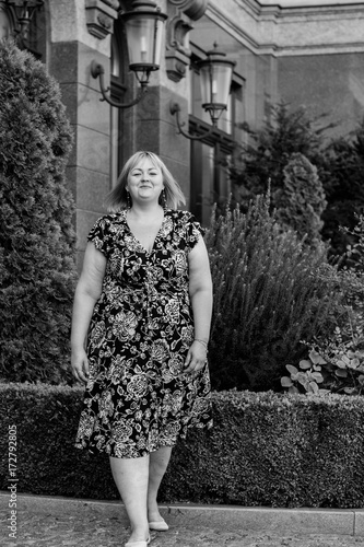 Portrait plus size young blond hair woman walk on city center in European streets 