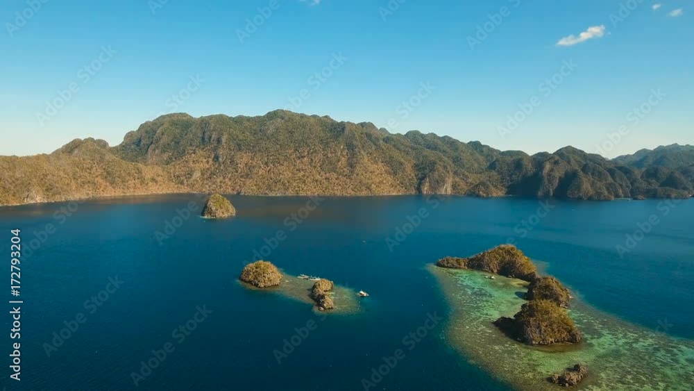 Aerial view: beach, tropical island, sea bay and lagoon, mountains with rainforest, Palawan. Lagoon with blue, azure water in the middle of small islands and rocks. Busuanga. Seascape, tropical Aerial view: beach, tropical island, sea bay and lagoon, mountains with rainforest, Palawan. Lagoon with blue, azure water in the middle of small islands and rocks. Busuanga. Seascape, tropical