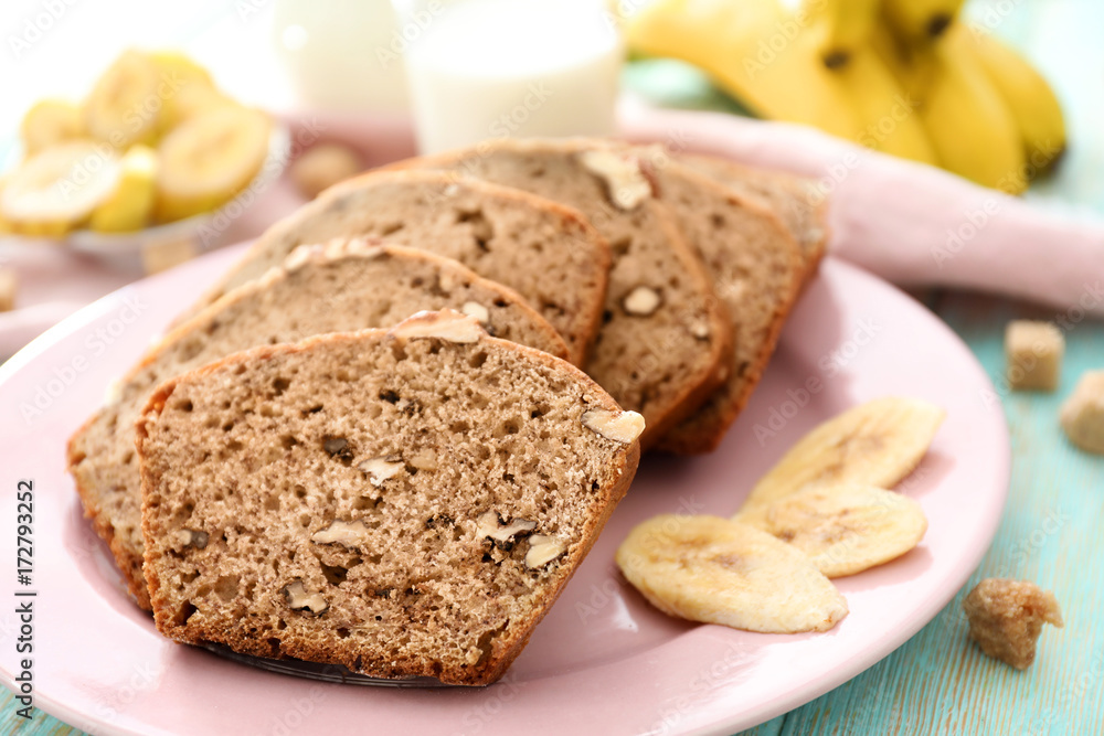 Fototapeta premium Sliced banana bread with nuts on plate