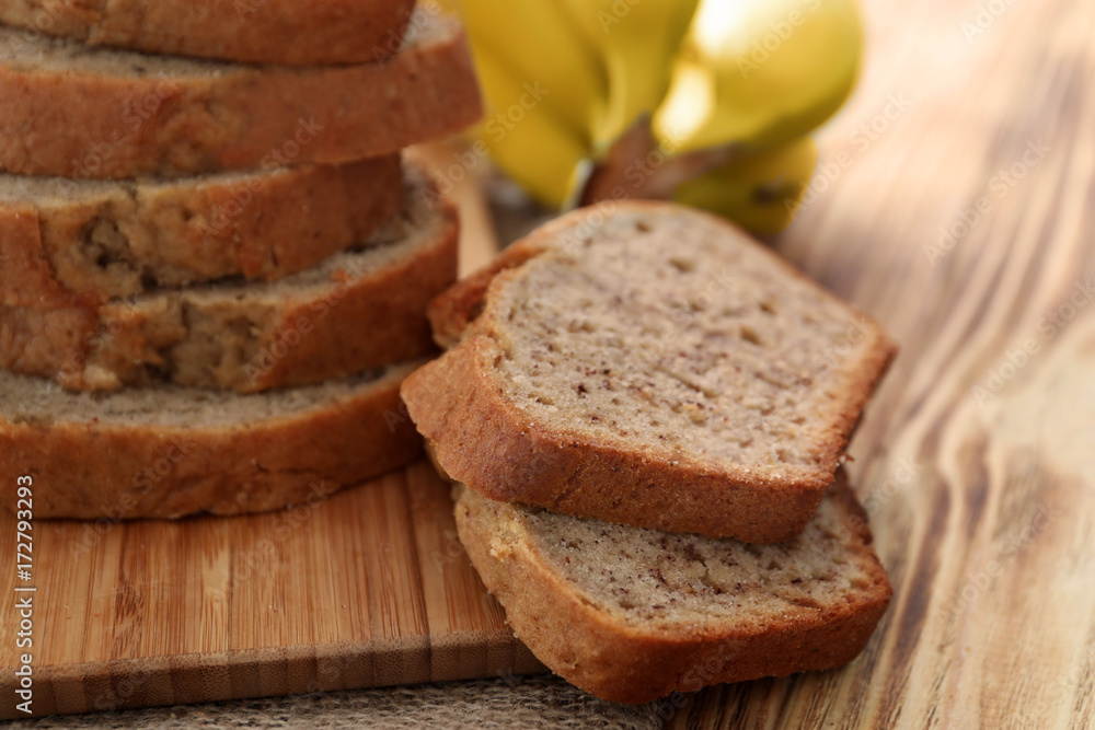 Sliced banana bread on wooden board Sliced banana bread on wooden board