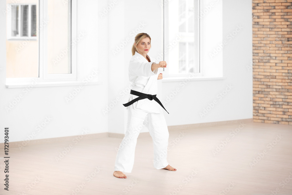 Female karate instructor training in dojo Female karate instructor training in dojo