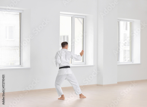 Male karate instructor training in dojo