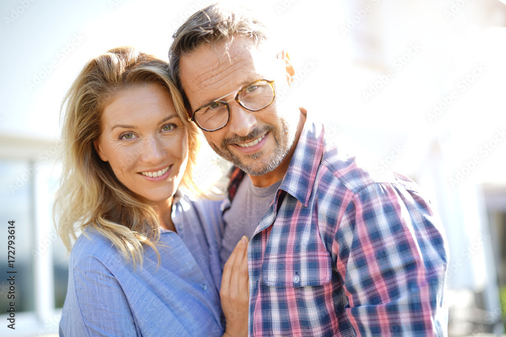 Portrait of mature couple relaxing in outdoor sofa Portrait of mature couple relaxing in outdoor sofa