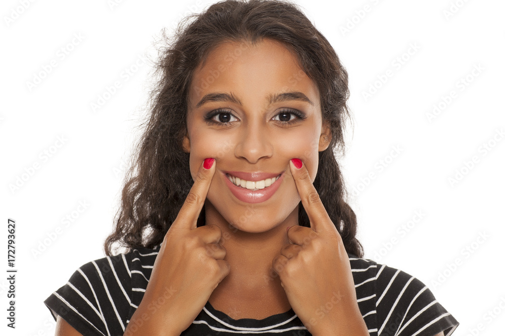 beautiful young dark skinned woman forsed her smile with her fingers beautiful young dark skinned woman forsed her smile with her fingers