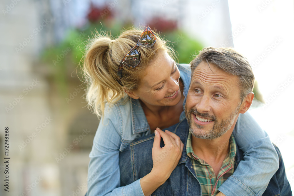 Man giving piggyback ride to woman