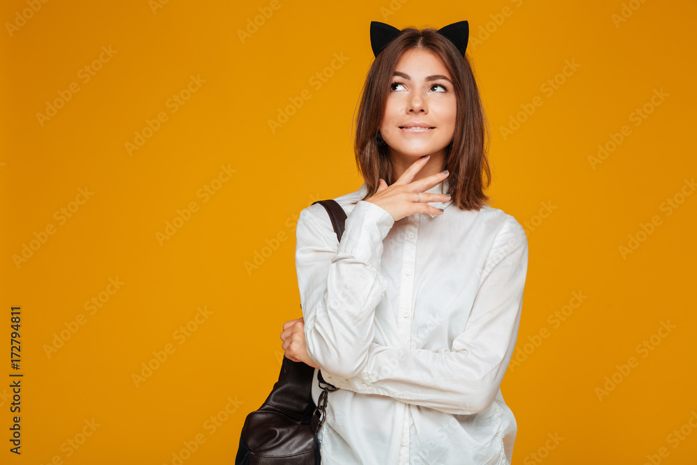 Fototapeta premium Young teenage schoolgirl in uniform with backpack