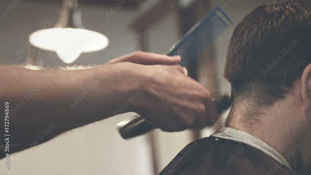Cutting hair with electric razor. Close up of male haircut. Man ...