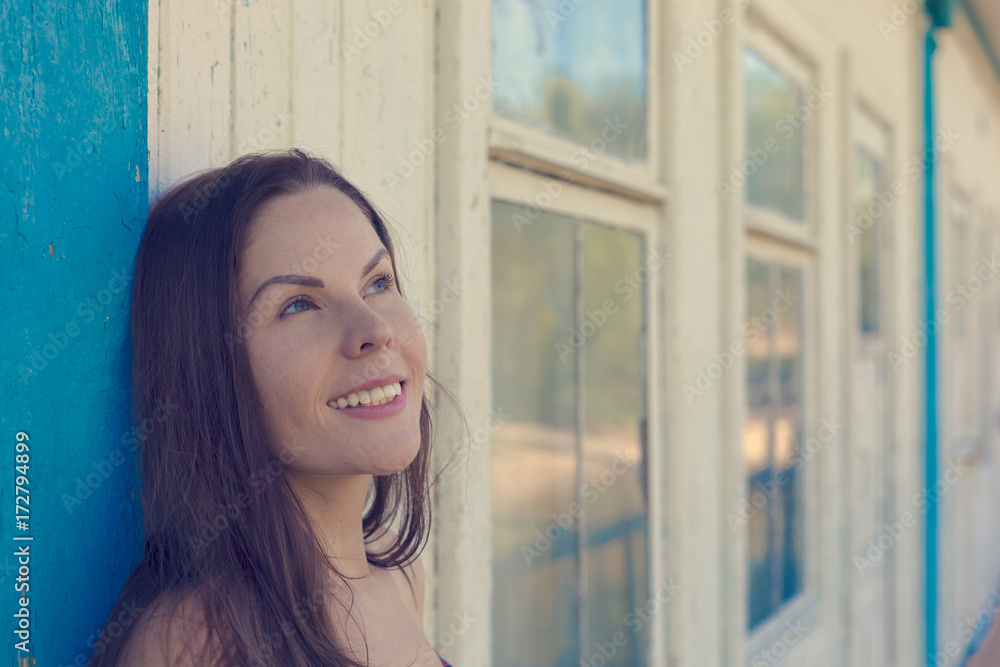 Portrait of a young woman next to a blue wooden background Portrait of a young woman next to a blue wooden background