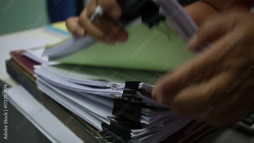 Officer Businessman searching data in Stacks of papers files on work desk in office, business report paper or piles of unfinished documents notation with clips on offices desk, Business concept Officer Businessman searching data in Stacks of papers files on work desk in office, business report paper or piles of unfinished documents notation with clips on offices desk, Business concept