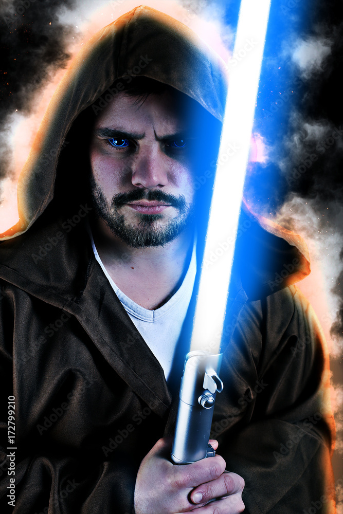 young warrior with brown hooded cape holding a laser sword young warrior with brown hooded cape holding a laser sword
