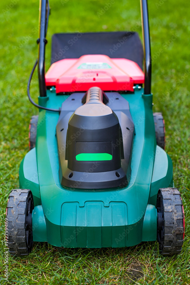Lawn mower in the backyard Lawn mower in the backyard