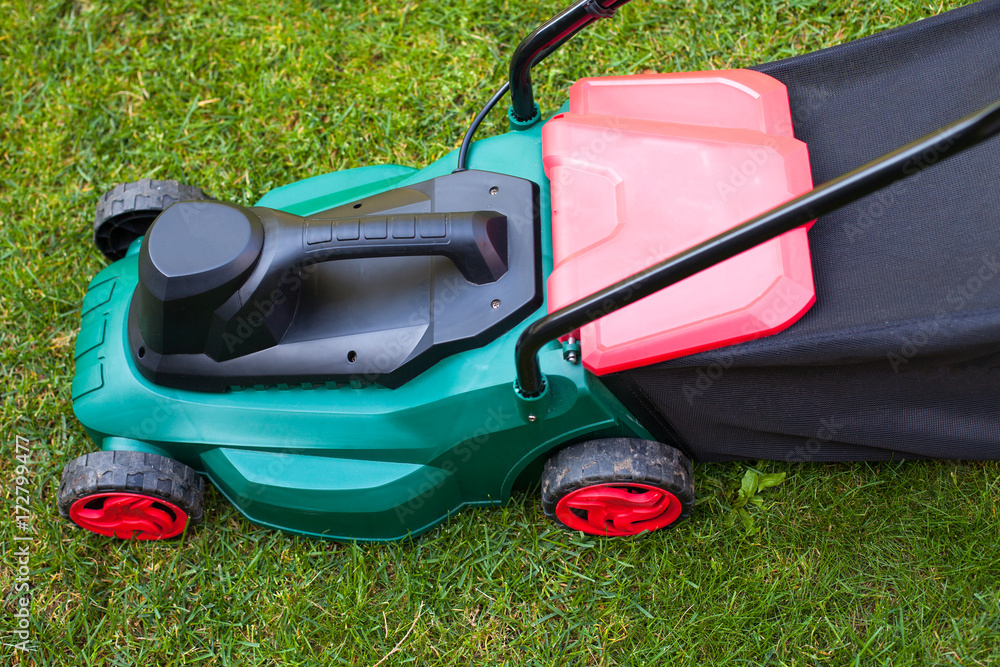 Lawn mower in the backyard Lawn mower in the backyard