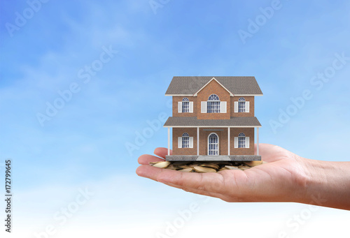 salesman person giving to buyer customer,house in hand