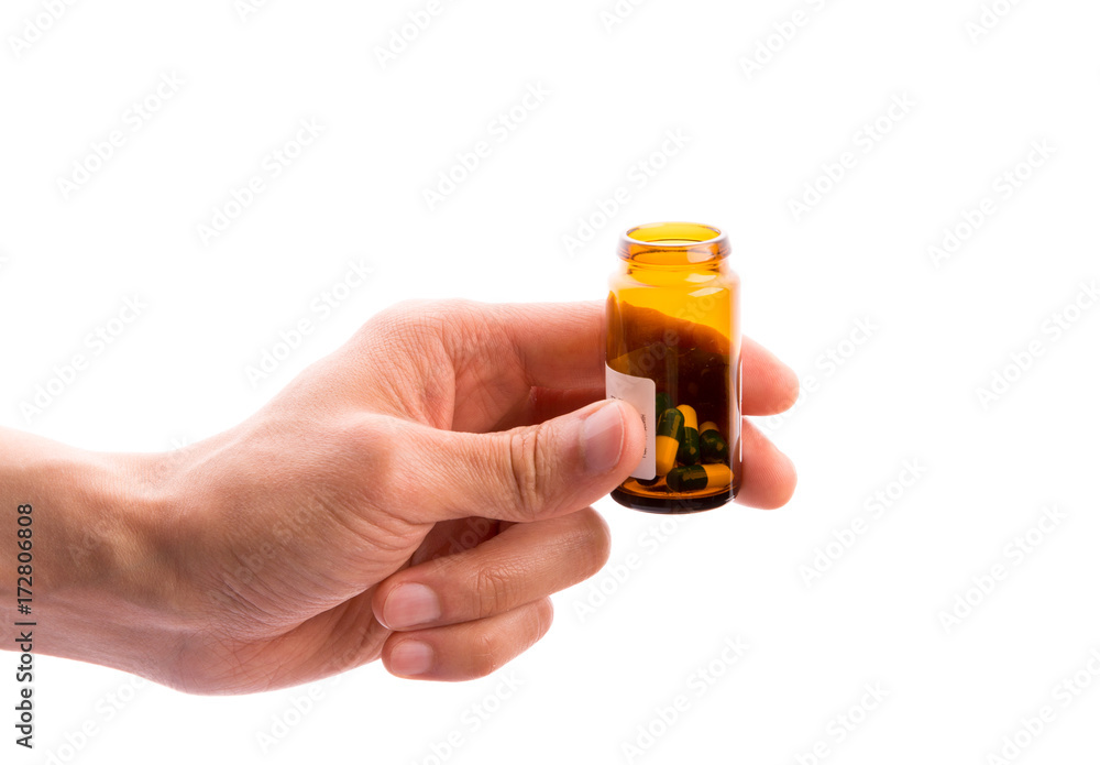 Medicine bottle capsule pills in hand isolated on white bacground Medicine bottle capsule pills in hand isolated on white bacground