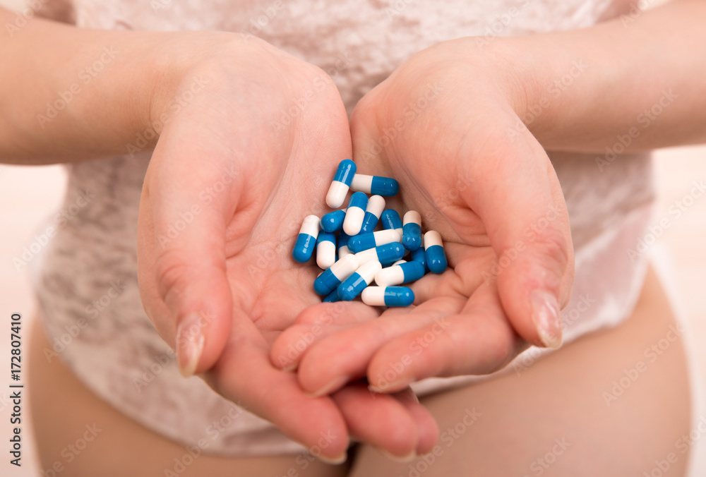 medicine pills in woman hands
