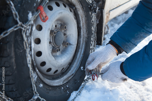 the mechanic puts chains on the wheels