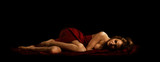beautiful woman lay naked on black background studio art