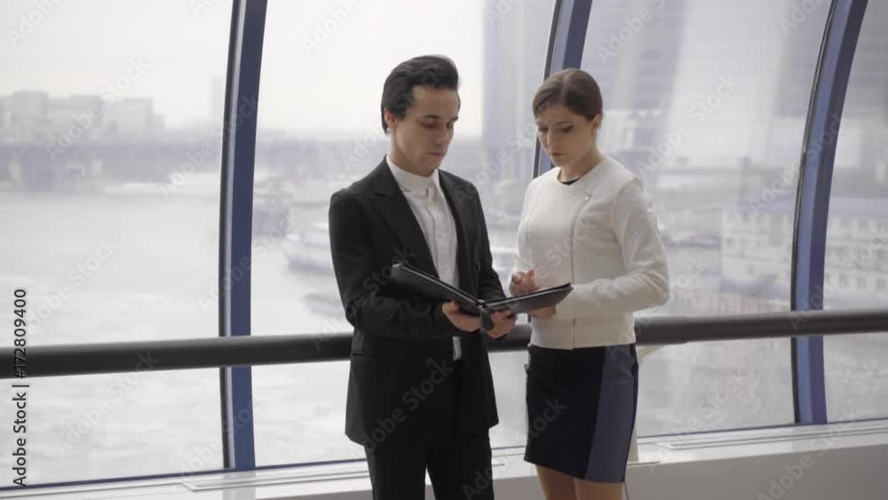 young business team stay opposite window in modern business centre and discuss document in case young business team stay opposite window in modern business centre and discuss document in case