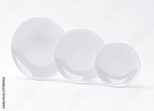 Plates of three different sizes on white background, 3D rendering