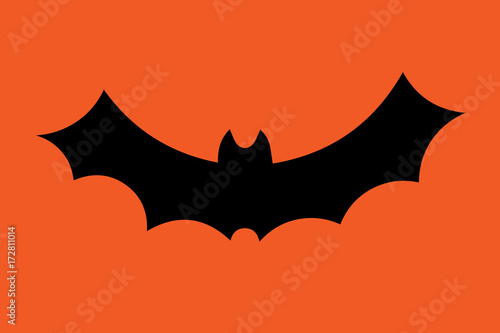 Flying bat silhouette isolated on orange. Vector illustration.