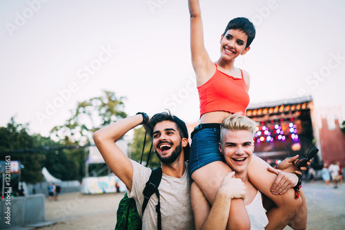 Group of friends having fun time at music festival