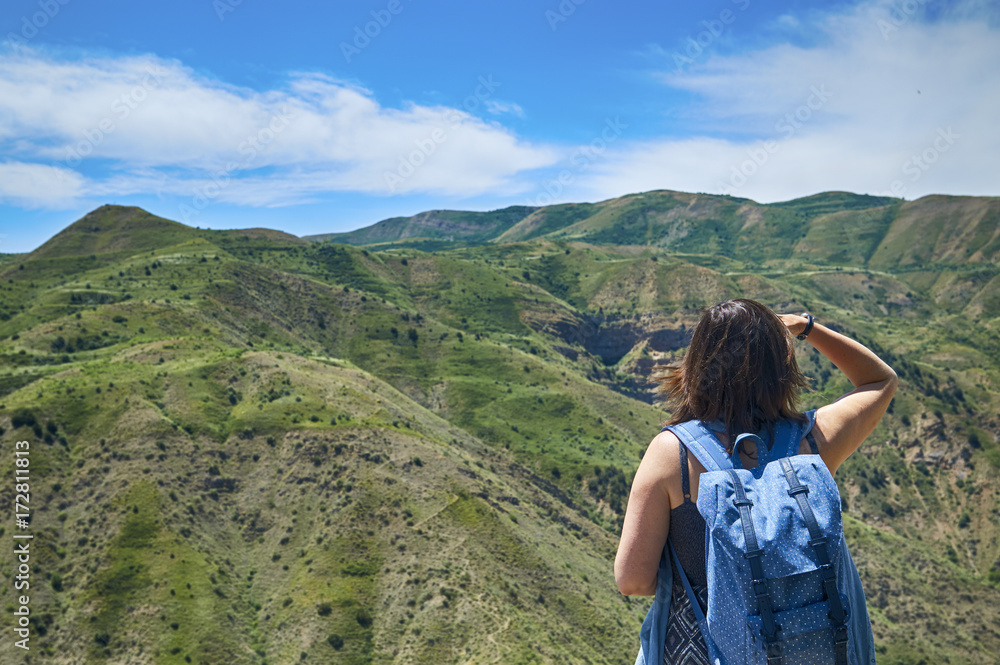 Woman with backpack enjoying beautiful mountain view Woman with backpack enjoying beautiful mountain view
