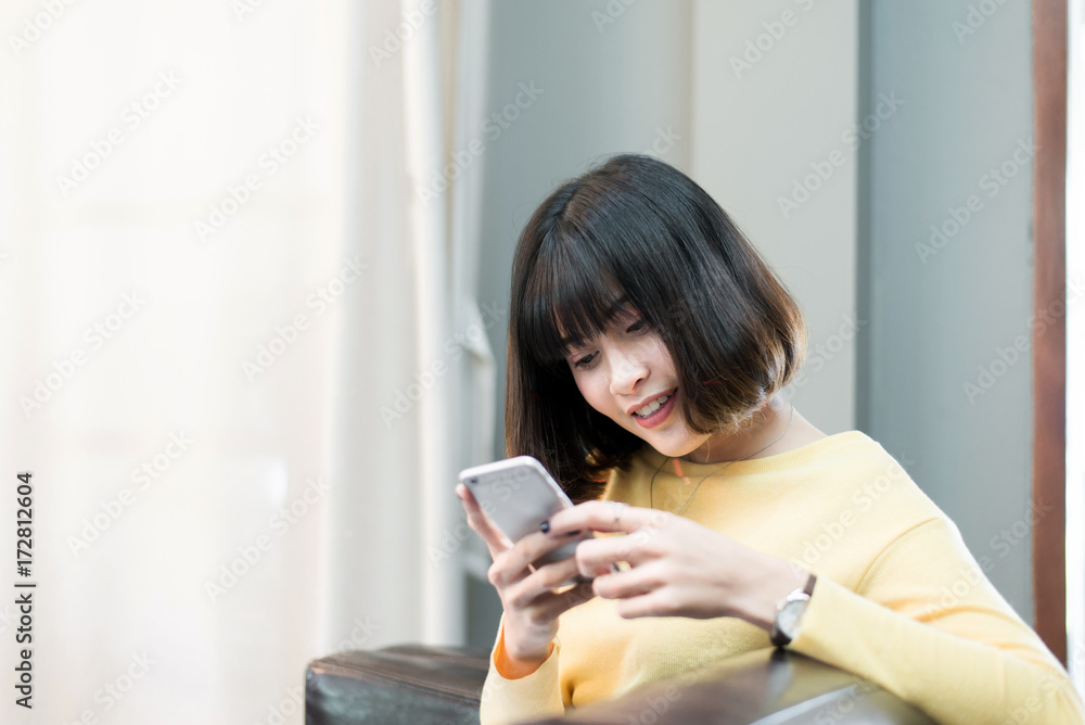 Beautiful Asian woman using and looking smart phone at home,Searching or social networks Beautiful Asian woman using and looking smart phone at home,Searching or social networks