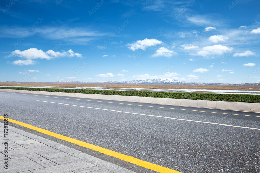empty asphalt road with snow mountains empty asphalt road with snow mountains