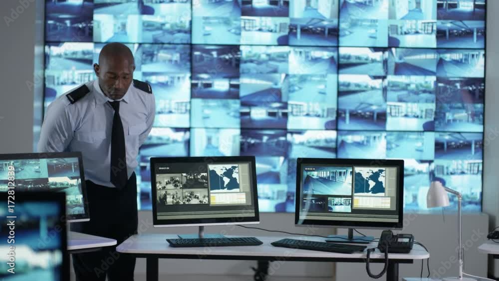 Portrait smiling surveillance officer in control room Portrait smiling surveillance officer in control room