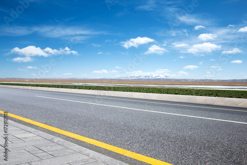 empty asphalt road with snow mountains © zhu difeng