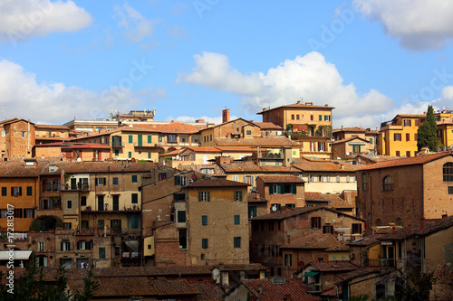 Beautiful landscape the roofs of houses of Europe Sienna old town in Italy under blue sky with clouds