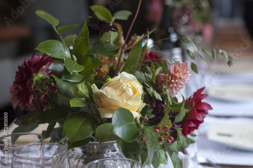 Fototapeta Naklejka Na Ścianę i Meble -  the Wedding bouquet of a bride from dahlias and roses decorates a wedding table in a restaurant