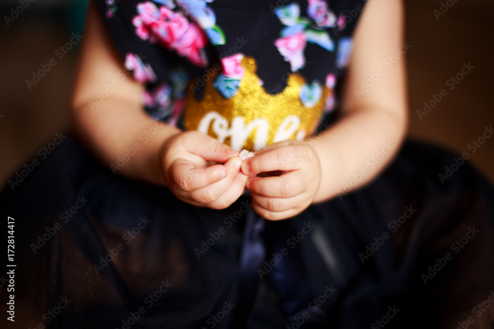 little girl's hand.f child in a smart dress.holding a small object in her hand . little girl's hand.f child in a smart dress.holding a small object in her hand .