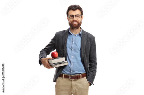 Teacher with an apple and books looking at the camera photo