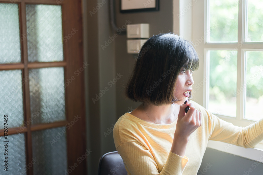 Healthy fresh asian cute girl makeup and applying lipstick fornt of mirror Healthy fresh asian cute girl makeup and applying lipstick fornt of mirror
