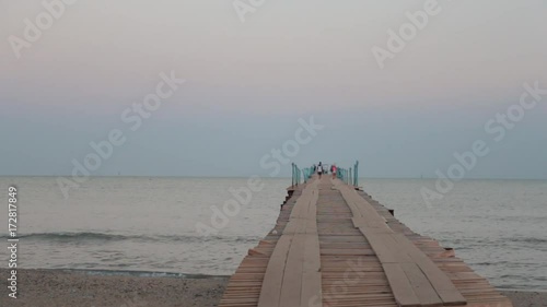 Landscape view of Tranquil Sunrise on the sea with wooden pier. photo