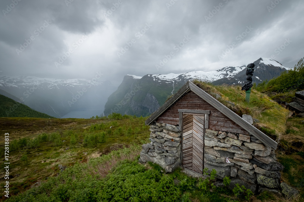 Scenic view of old wooden house with grass on the roof, traditional norway house.