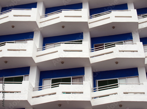 modern apartments with white balconies and blue details with angular railings © Philip J Openshaw 