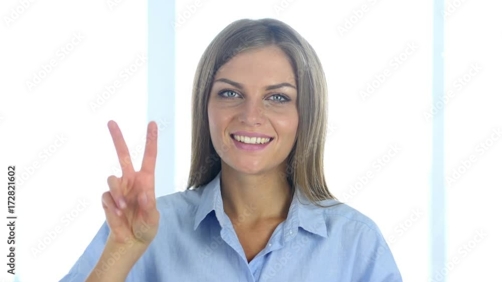 Portrait of Successful Young Woman Gesturing Victory Sign Portrait of Successful Young Woman Gesturing Victory Sign