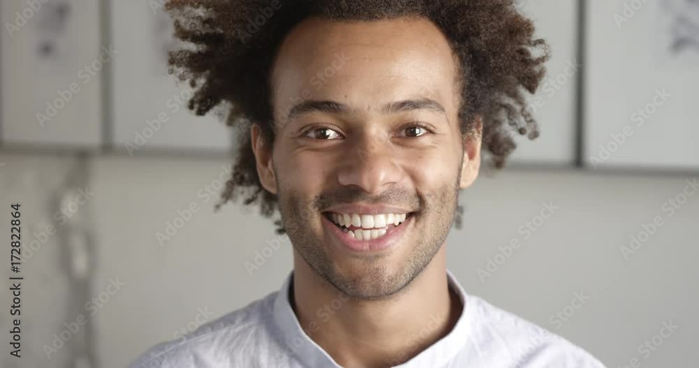 Portrait of smiling african designer happy to provide services for online marketplaces. Close up. Slow motion. Portrait of smiling african designer happy to provide services for online marketplaces. Close up. Slow motion.