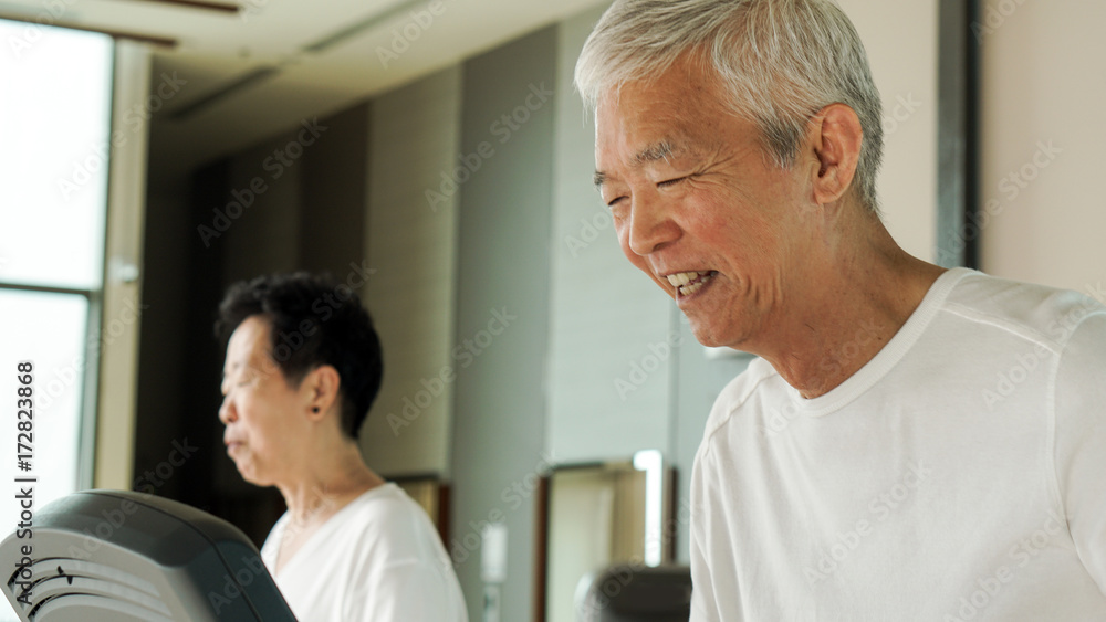 Happy Asian senior couple running on treadmill healthy lifestyle Happy Asian senior couple running on treadmill healthy lifestyle