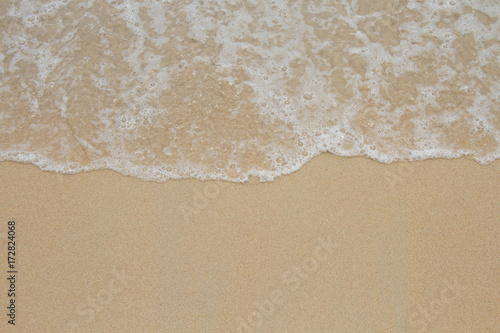 Beach wave tide on sand background