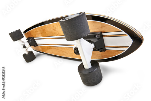 Dynamic side view of a Black and wooden skate board isolated photo