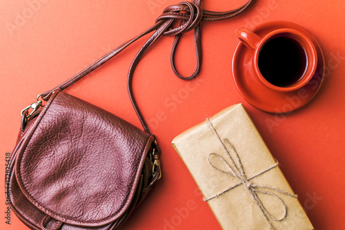 Bag, gift and coffee Cup on red background