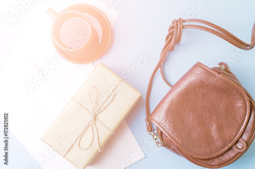 Bag, gift and coffee Cup on blue background